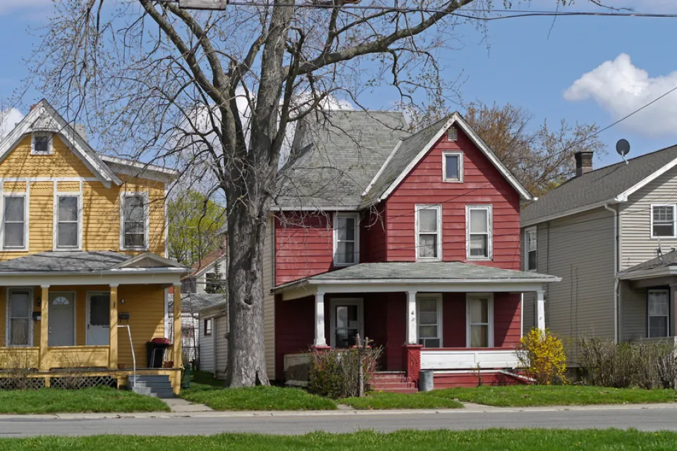 Old houses with large porch and colorful siding
